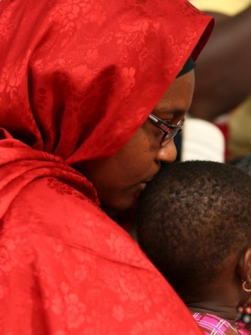 A mother kisses her daughter as they participate in protest demanding the release of the abducted...