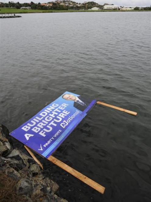 A National Party hoarding is seen floating in the Andersons Bay inlet yesterday. Photo by Craig...
