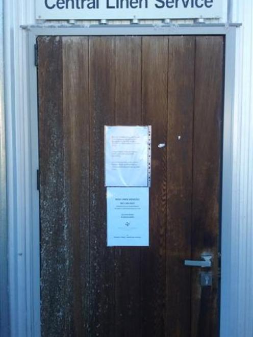 A notice on the door of Wanaka's only commercial laundry says DSCRQ Ltd, trading as Central Linen...
