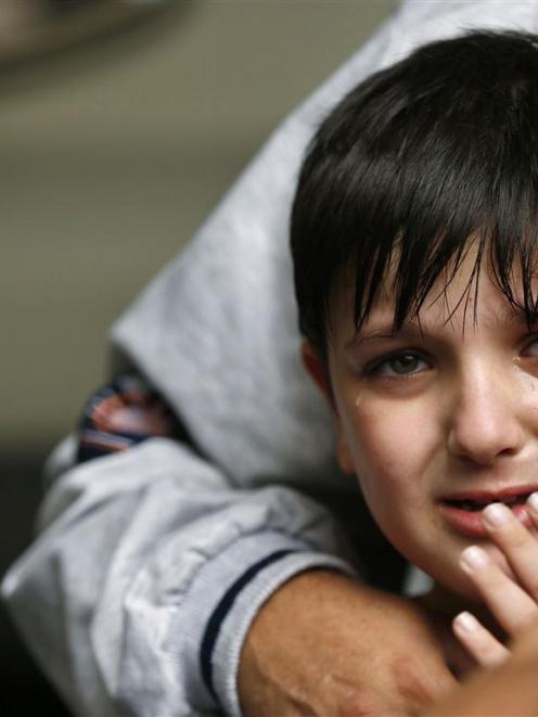 A Palestinian boy cries after what witnesses said was an Israeli air strike in Gaza City. A truce...