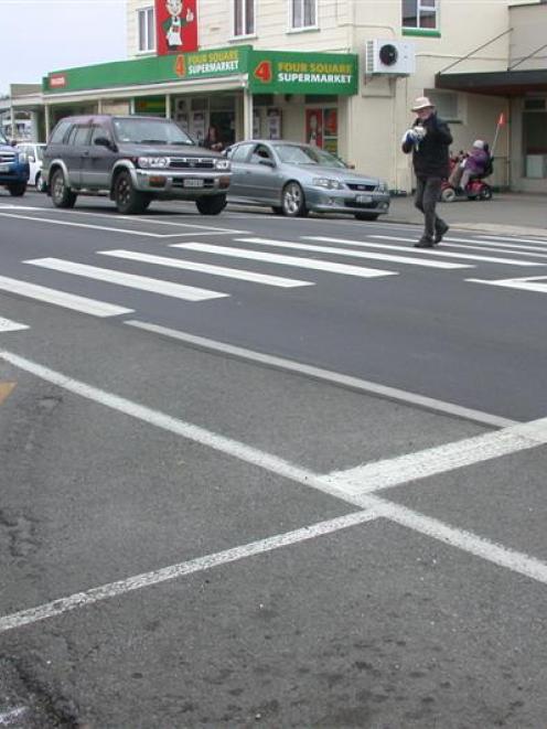 A pedestrian uses the crossing in north Oamaru a woman says needs  lights to make it safer. Photo...