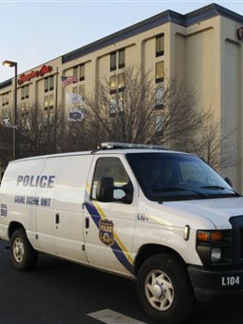 A Philadelphia Police Department Crime Scene Unit van pulls away from a Hampton Inn in...