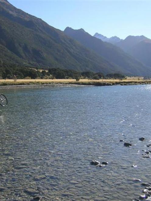 A photographer captures a mountain-biker crossing the Hunter River during the Contact Epic Round...