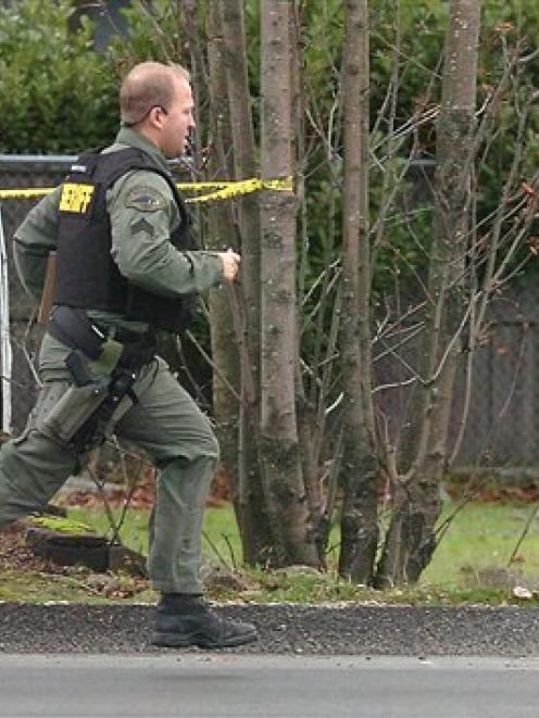 A Pierce County Sheriff deputy runs to the site where four police officers were killed in an...