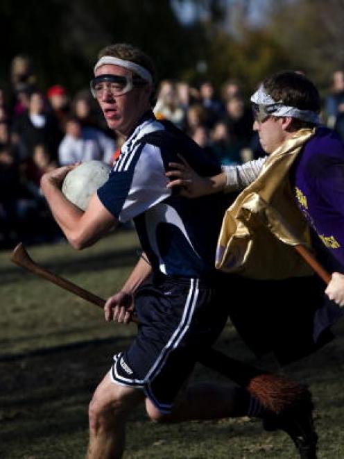 A player from Middlebury College rushes past a player from Emerson College in an Intercollegiate...