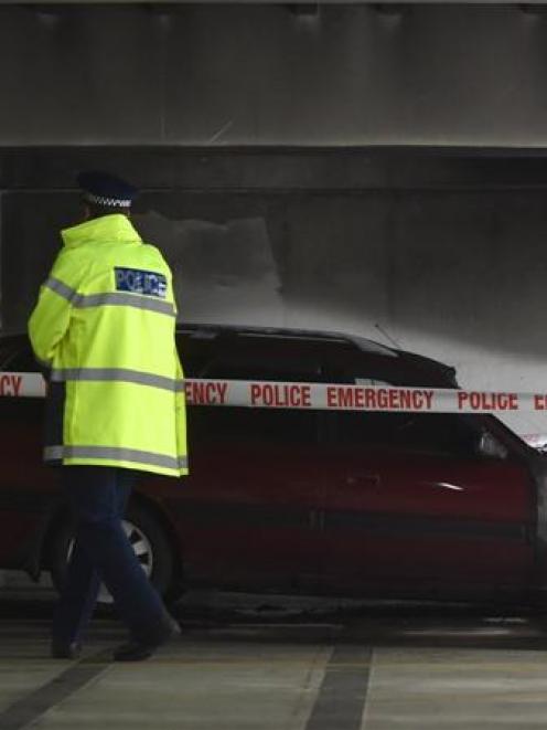 A police officer at the scene of Saturday's car fire at Wilson  Park building in Moray Pl. Photo...