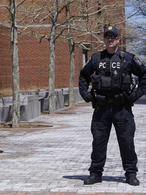 A police officer stands guard outside of John Joseph Moakley United States Courthouse in Boston....