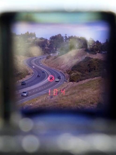 A police speed laser scans traffic on Dunedin's Southern Motorway near Fairfield yesterday. Photo...