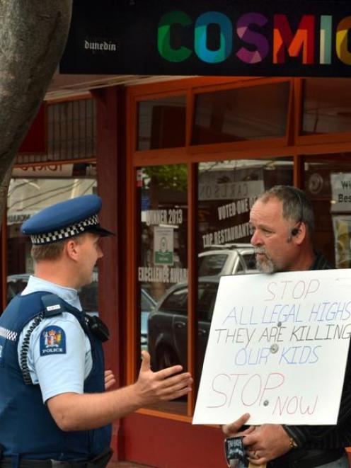 A policeman talks to Calvin Hooper about his protest in Dunedin yesterday against synthetic...