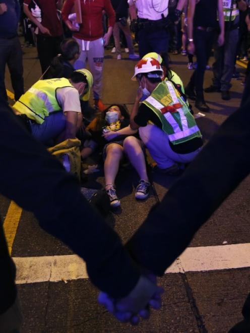 A protester receives medical treatment after a confrontation with riot police on Portland Street...