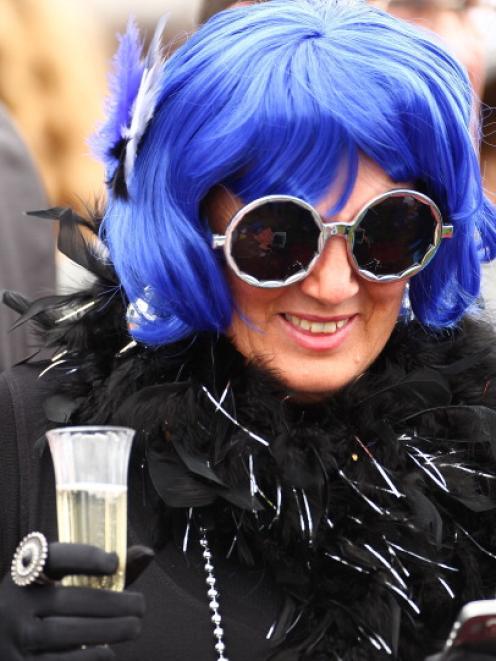 A racegoer enjoys the atmosphere during Melbourne Cup Day at Victoria's Flemington Racecourse in...