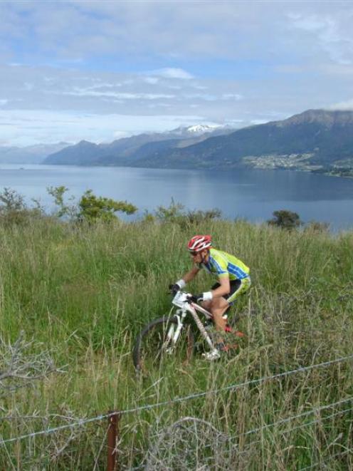 A racer rides beside Lake Wakatipu during the 8hrs@Jacks cycle event. Photo by Christina McDonald.