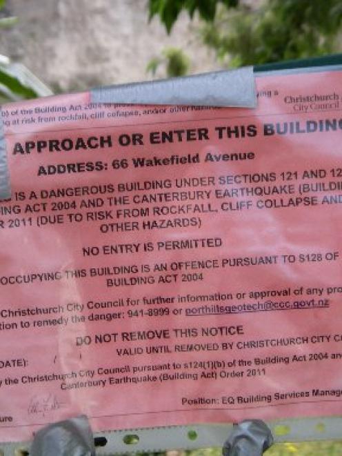 A red-sticker marking a dangerous building in Christchurch.