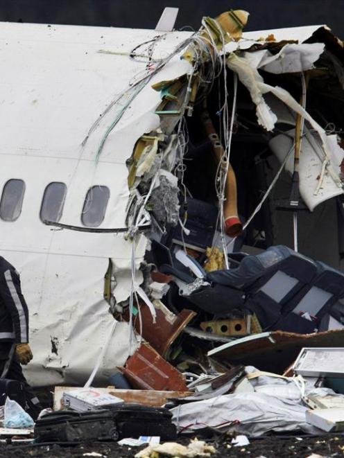 A rescue worker is seen near the wreckage of a Turkish Airlines aeroplane at Amsterdam's Schiphol...