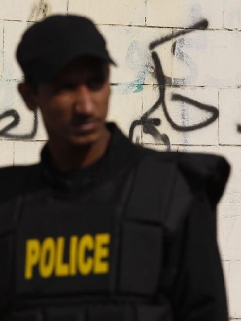 A riot police officer stands guard at the scene of a bomb blast in Cairo's Nasr City district....