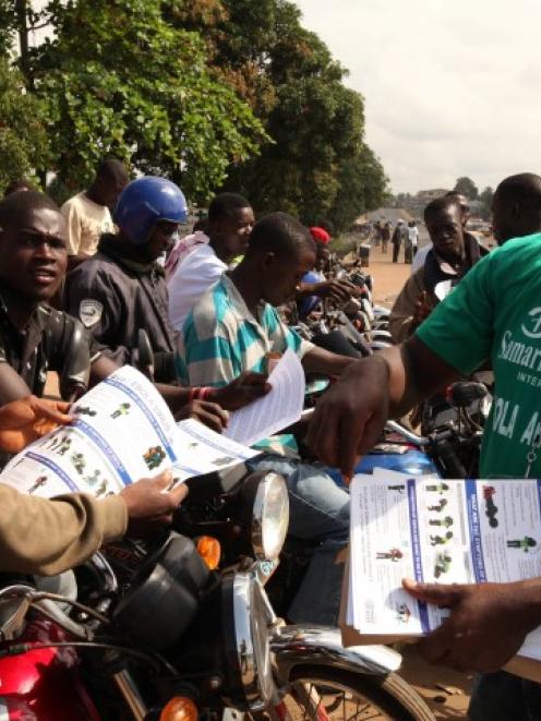A Samaritan's Purse team member hands out pamphlets to educate the public on the Ebola virus in...