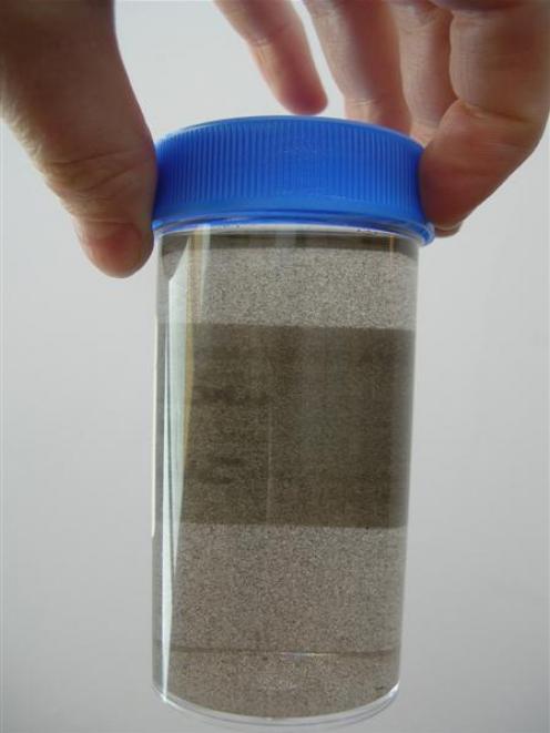 A sample of Cromwell's domestic water supply showing manganese particles, which the Cromwell...
