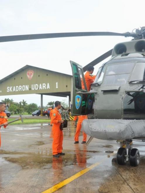 A search and rescue squad from the Indonesian Airforce prepare to depart to take part in the...