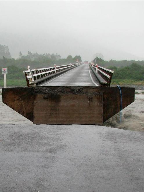 A section of the Wanganui River bridge, near Harihari, on the West Coast, which was swept away by...