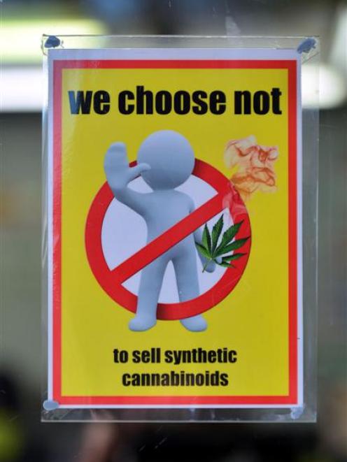 A shop displays a sign indicating it does not sell synthetic cannabis products. Photo by Peter...