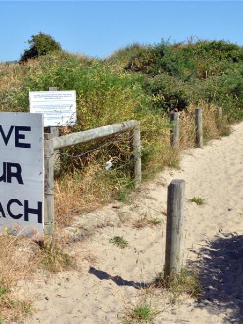 A sign erected by locals at Te Rauone, where erosion is affecting a council reserve.