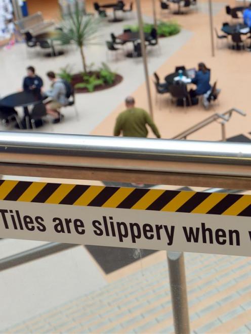 A sign warns of the slippery floor in the University of Otago commerce building. Photo by Stephen...