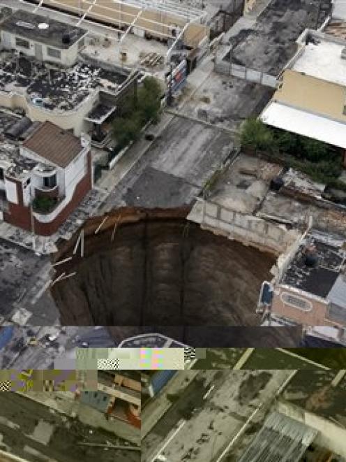 A sinkhole covers a street intersection in downtown Guatemala City. Photo by AP.