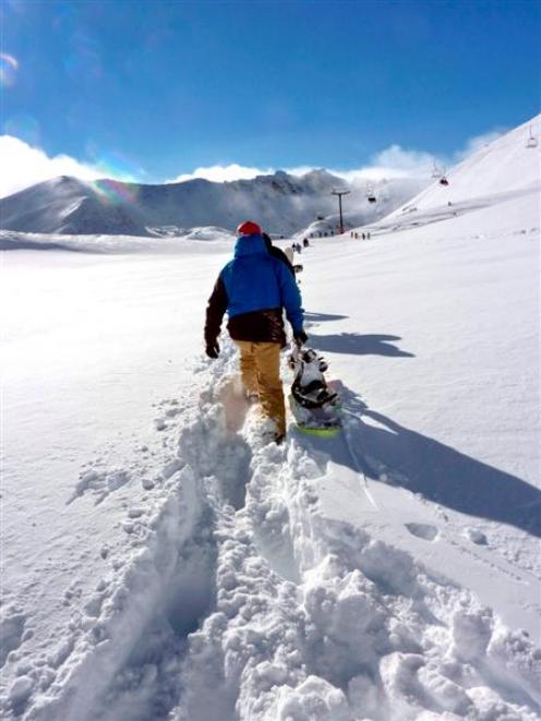 A snowboarder hikes in the new snow at the Remarkables. Photo by Wendy van Dijk.