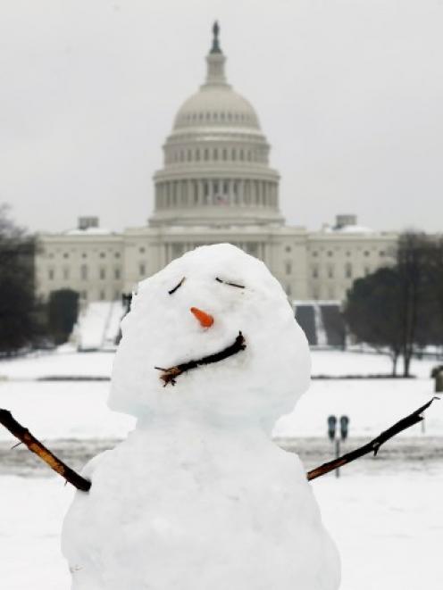 A snowman stands in front of the US Capitol in Washington. REUTERS/Kevin Lamarque