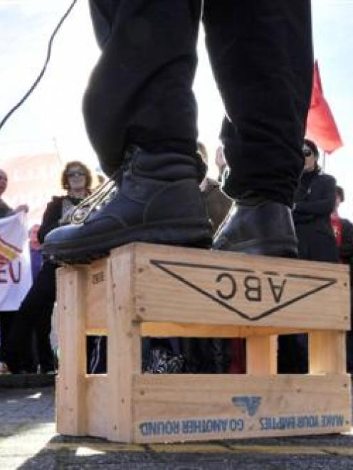 A speaker addresses the crowd of about 200 people attending a protest held at the Dunedin Railway...