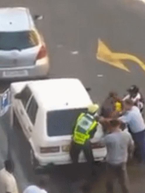 A still from the video which shows two police officers assaulting a man suspected of robbery in...