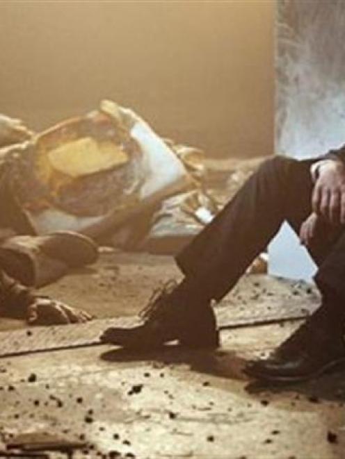 A stunned Jack Bauer (Kiefer Sutherland) sits beside the body of Bill Buchanan (James Morrison)...