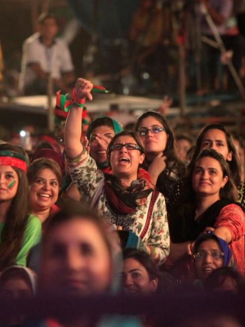 A supporter (C) of Imran Khan gestures while chanting with others during what has been dubbed a ...