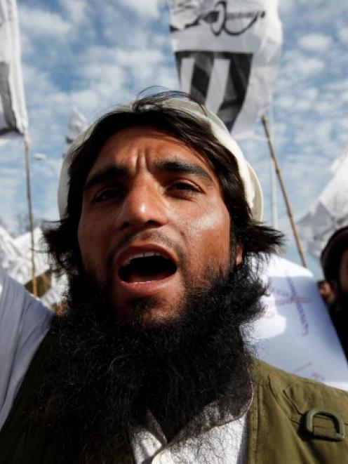 A supporter of the Jamaat-ud-Dawa Islamic organization takes part in an anti-India demonstration...