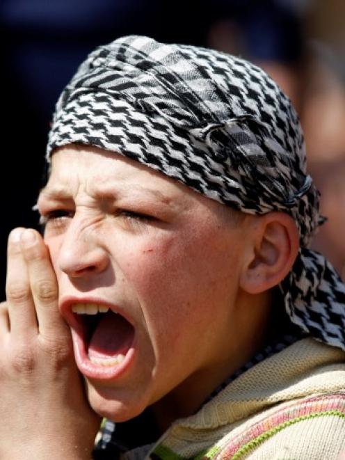 A Syrian refugee boy shouts slogans during a protest against Syrian President Bashar al-Assad at...