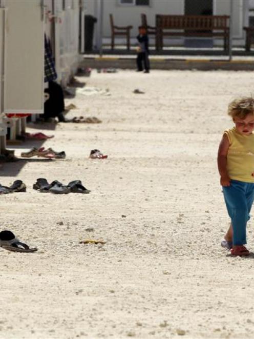 A Syrian refugee girl walks inside the Mrajeeb Al Fhood refugee camp, 20km  east of the city of...
