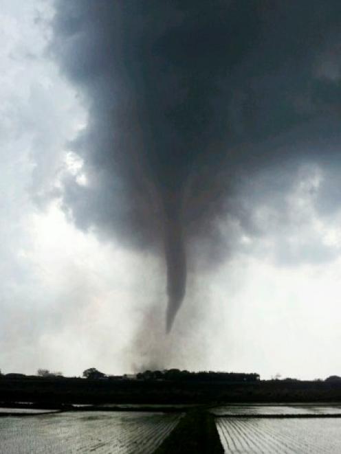 A tornado is seen in Tsukuba, north of Tokyo, in this picture taken by a resident yesterday....