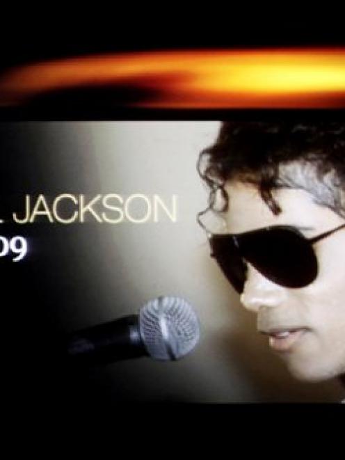 A tribute to Michael Jackson is seen on a screen during the ASCAP Rhythm & Soul Music Awards on...