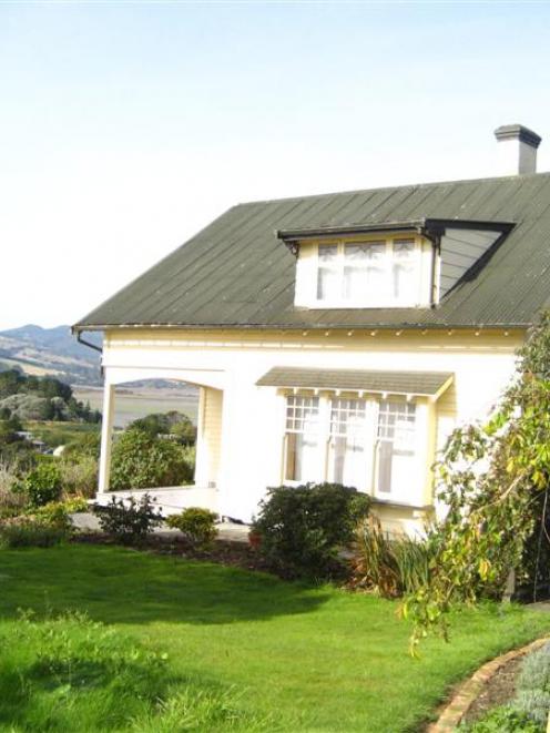A turn-of-the-century wooden house overlooks Warrington and Blueskin Bay.