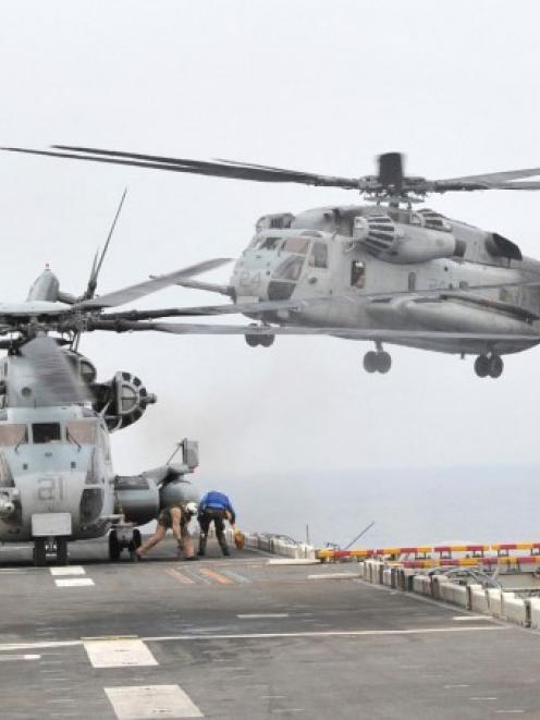 A US helicopter takes off from the USS Bonhomme Richard LHD 6 in the sea off Pohang yesterday....