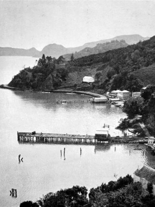 A view in the beautiful Whangaroa Harbour, North Auckland, showing a coastal steamer at the wharf...