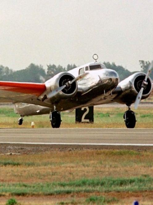 A vintage Lockheed Electra aircraft piloted by Linda Finch lands in Oakland, California,...