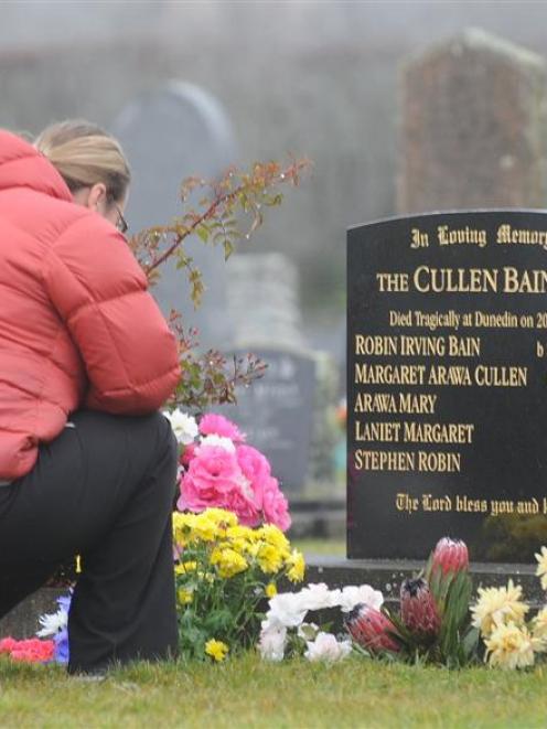 A woman visits the graves of the Bain family. Photo by Peter McIntosh.