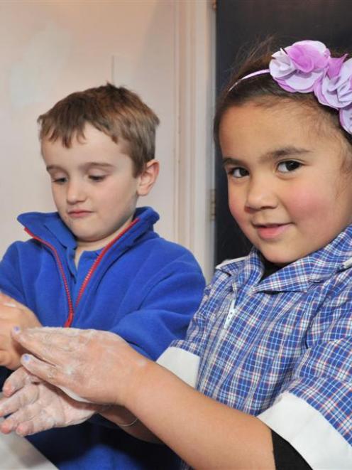 Abbotsford School pupils Harry Bond (left) and Layla Barton  (both 5) wash their hands in a bid...