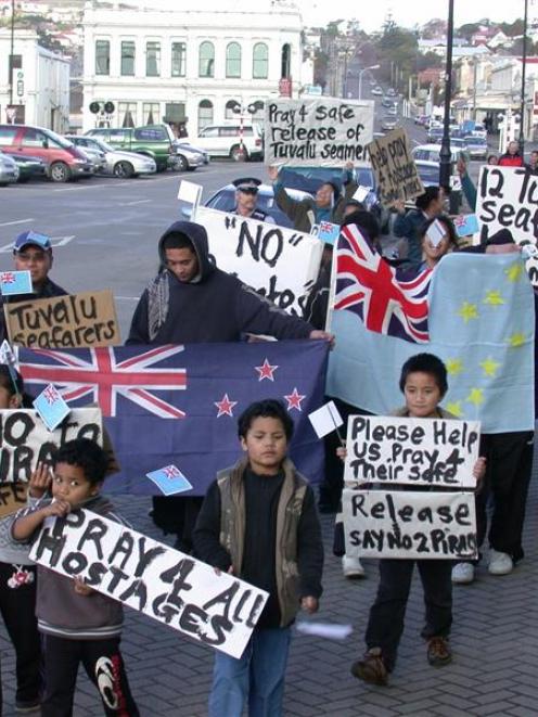 About 40 Tuvaluans and their supporters march through Oamaru yesterday calling for the release of...
