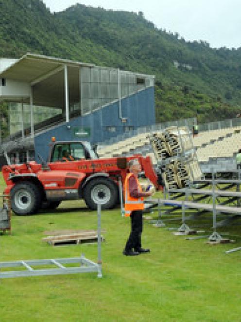 Workers erect temporary grandstands at the Omoto Racecourse for Thursday's memorial service
