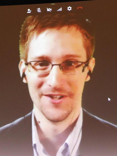 Accused US government whistleblower Edward Snowden is introduced to supporters of Amnesty...