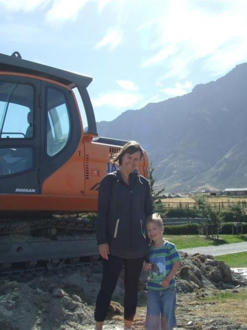 ack's Point resident Sarah Somerville stands with her son Noah Clarke (4) at the construction...