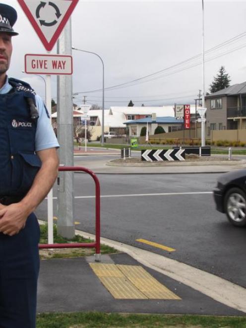 Acting Sergeant Derek Ealson checks driver behaviour in the new roundabout yesterday. Photo by...