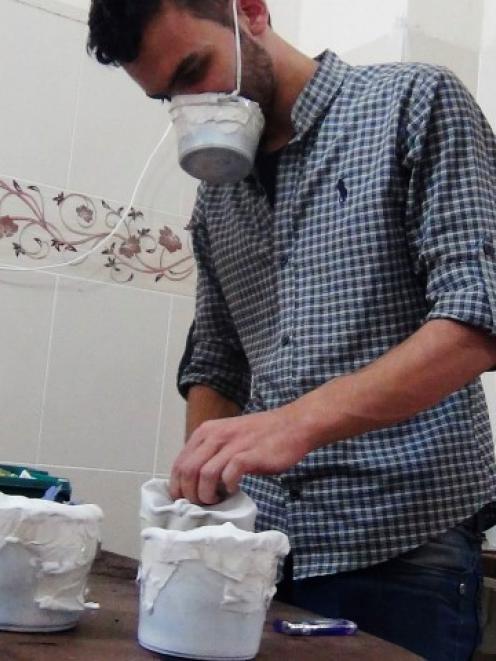 Activists and medics manufacture homemade chemical masks in the Damascus suburb of Zamalka....